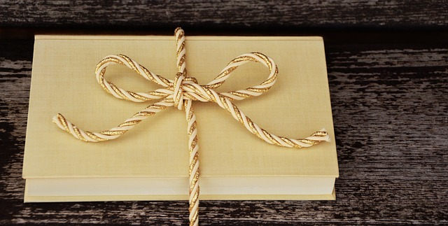 A book tied with a gold and white string