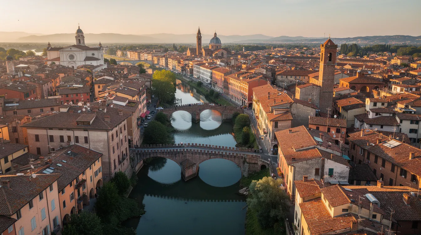 An aerial view of an Italian city showcases a picturesque landscape of red rooftops, a winding river, and historic bridges, embodying the charm of Italy's urban architecture. This scene captures the essence of the country, inviting viewers to explore its rich history and vibrant culture.