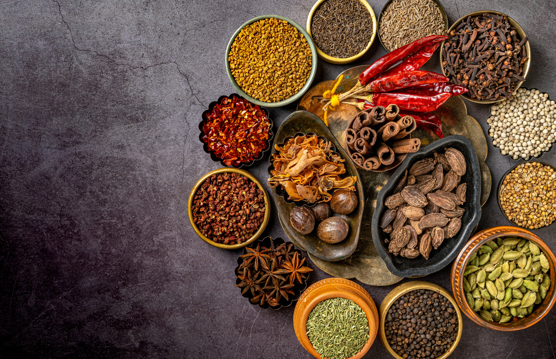 Assorted Indian spices including turmeric, cumin, coriander, and chili powder, etc.