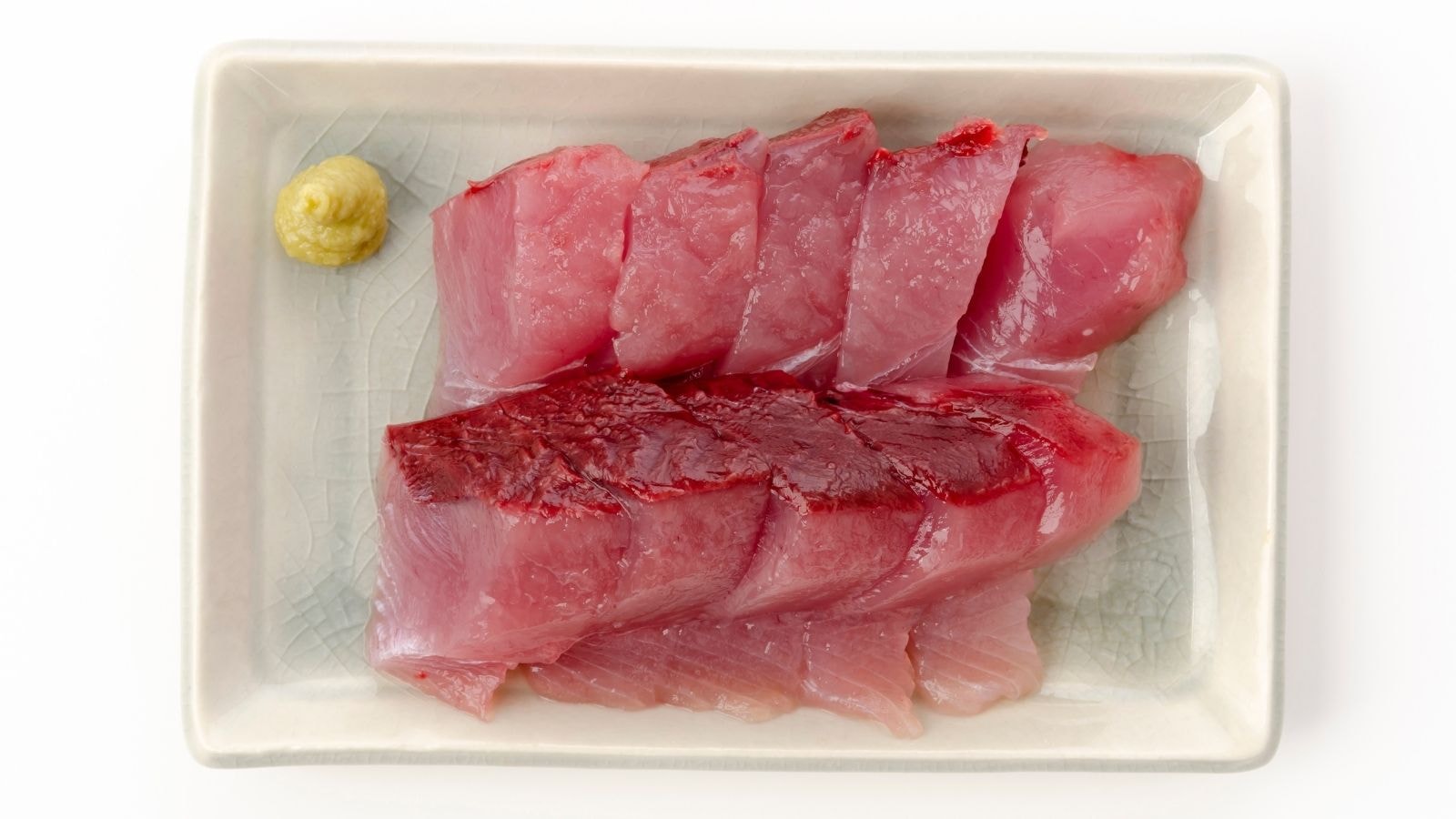 Fresh tuna slices served on a plate with wasabi