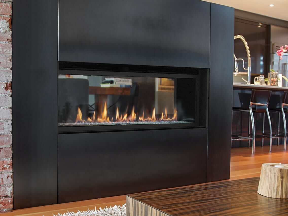 black wall with see through fireplace in the indoor near living room and kitchen