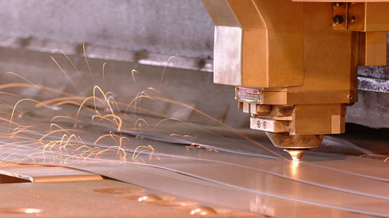 A laser beam from a laser cutting slicing a metal sheet.