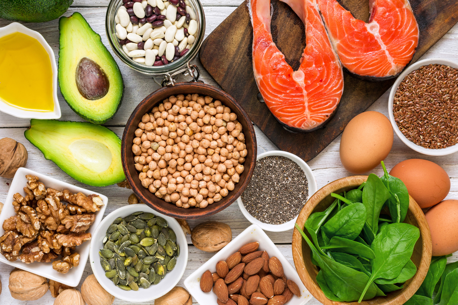 Overhead flat lay photograph of fresh vegetables, fruits, and omega-rich fish.