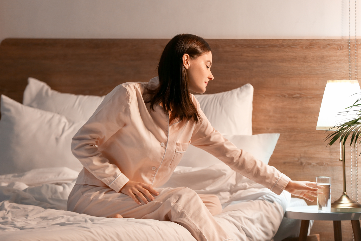Nighttime scene with a glass of water and a tidy bedroom setup for sleep.