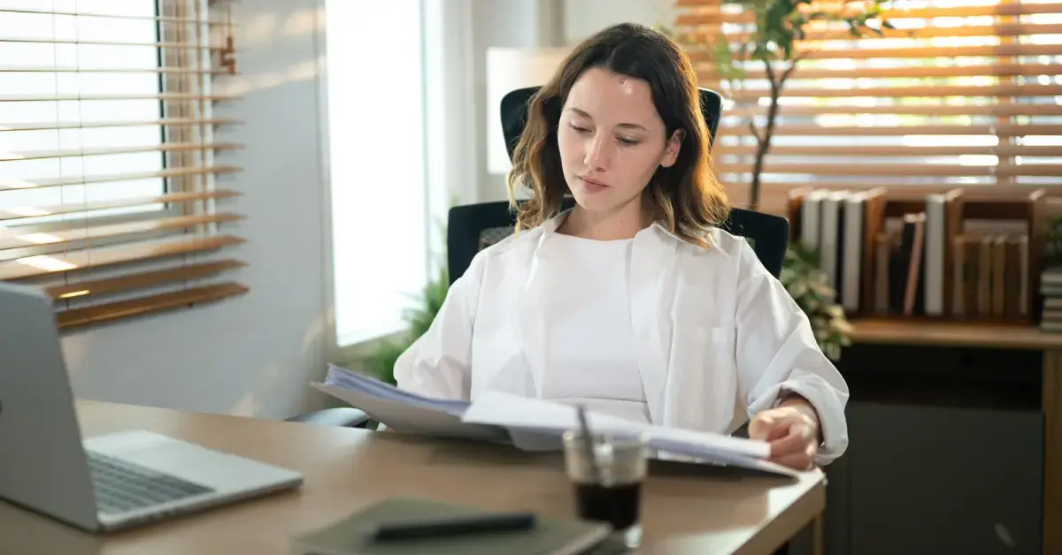Woman reviewing an IRS notice while researching IRS penalty abatement options for her tax account.