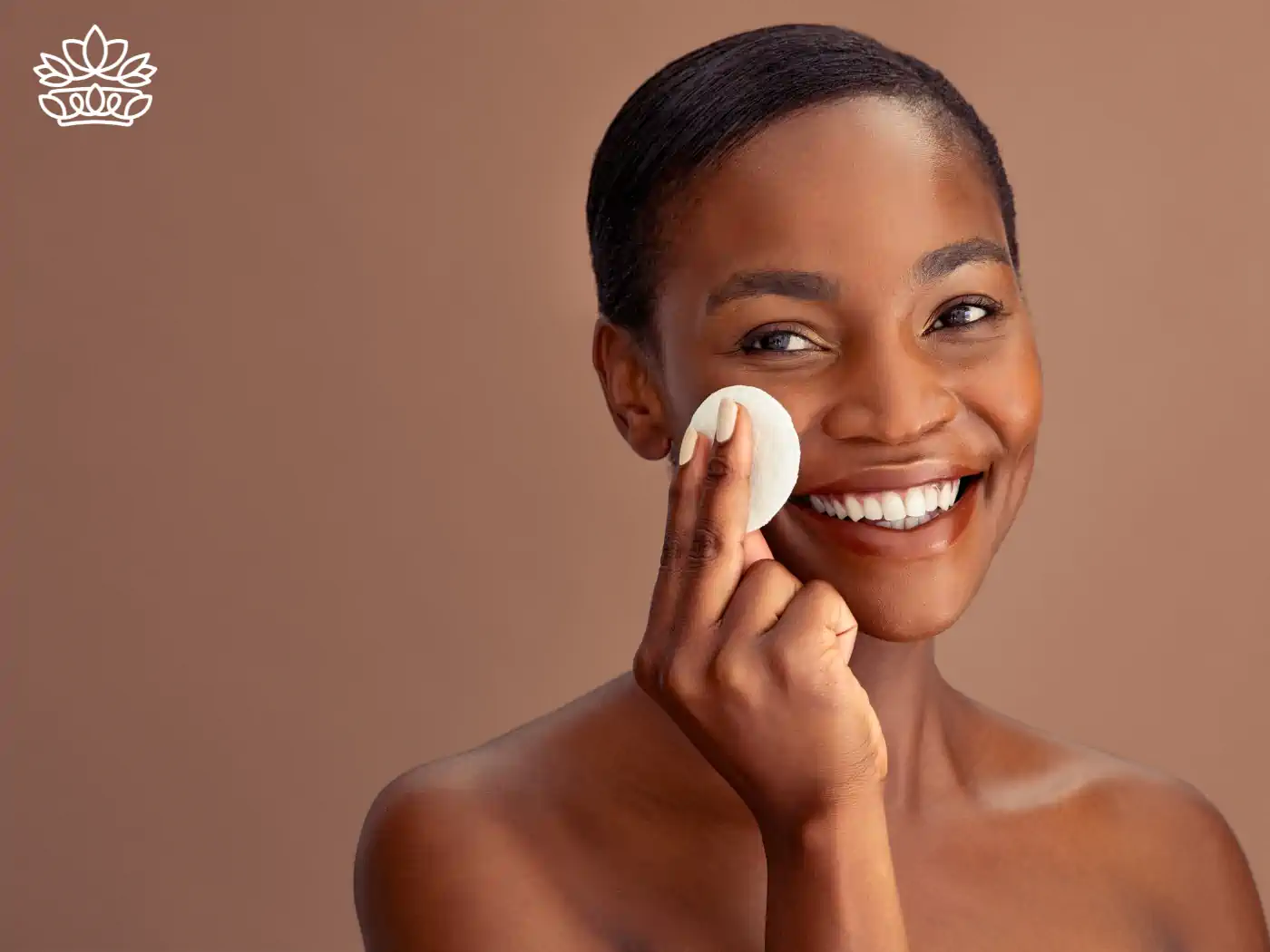  Woman smiling while holding a cotton pad to her face, symbolizing a gentle skincare regimen. Fabulous Flowers and Gifts.