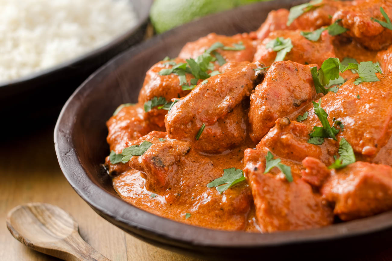 Raj's Corner Sydney Delicious Kadai Chicken - Spicy Indian curry in a traditional serving wooden plate.