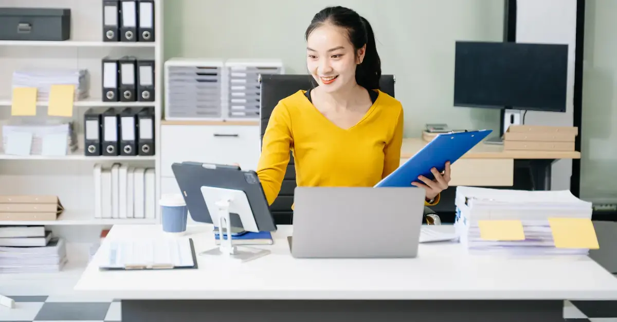 Woman organizing financial records and receipts to manage how to avoid double taxation.