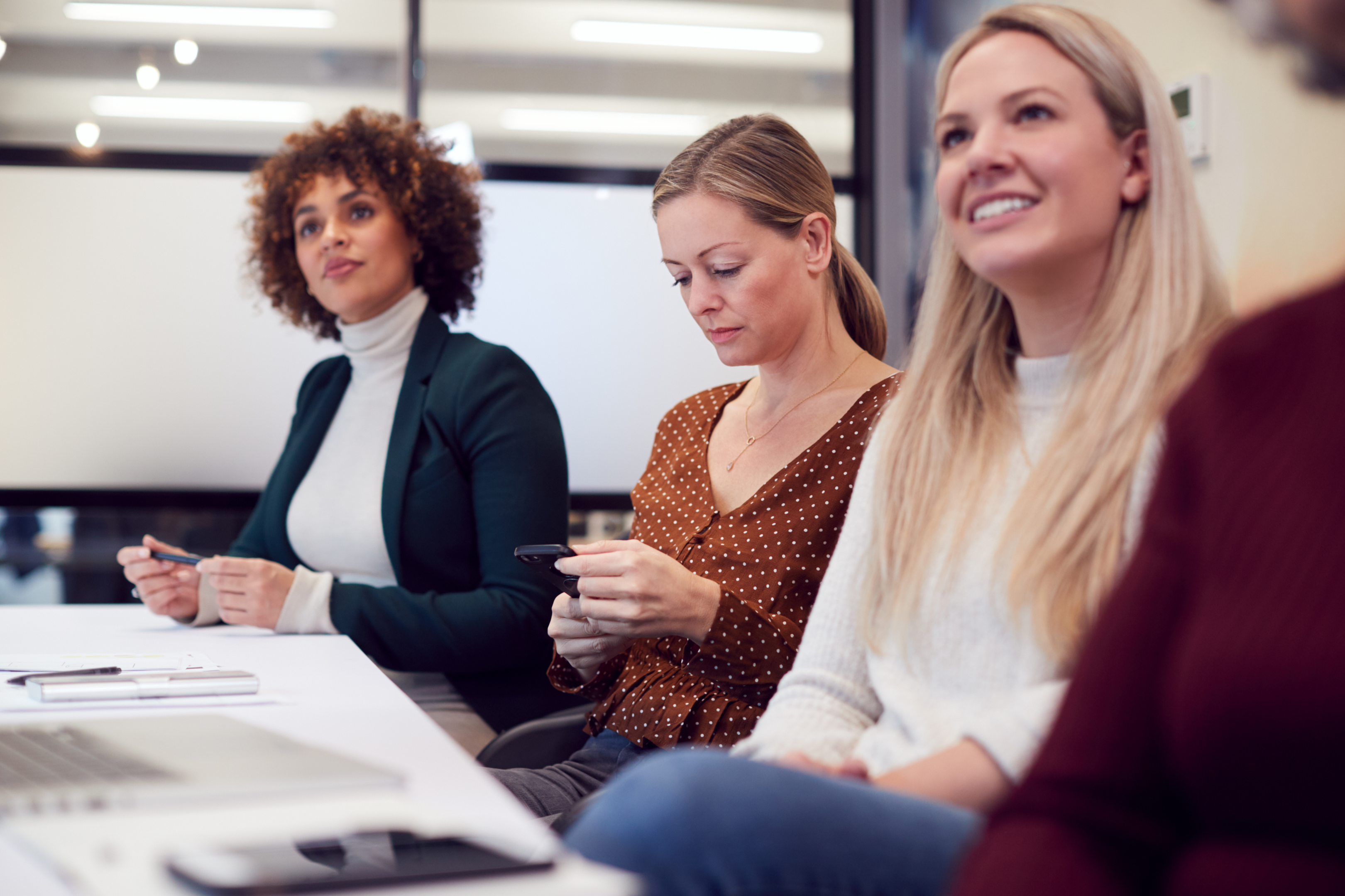 woman checking out and disengaged in a meeting