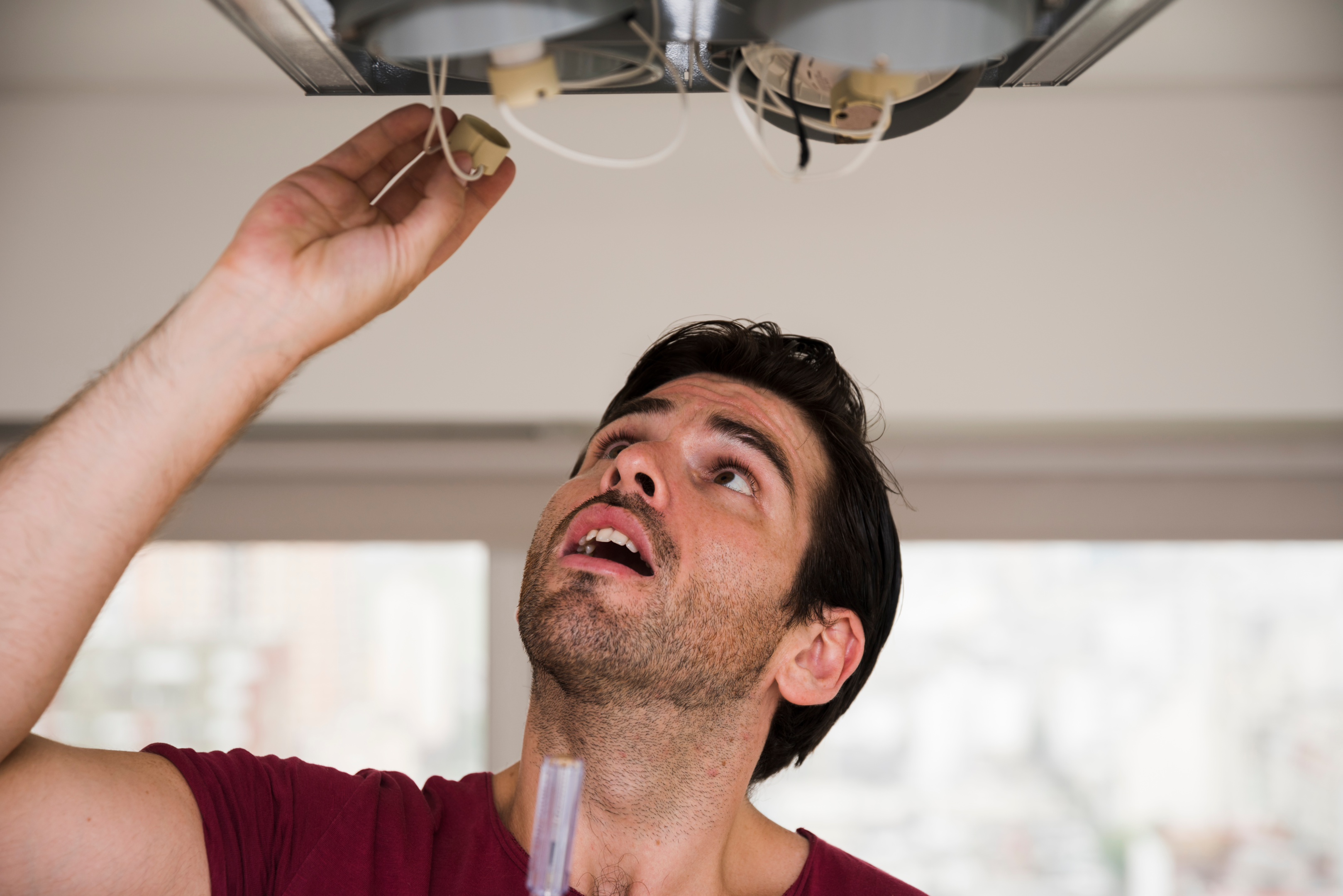 Dedicated plumber diligently repairing a malfunctioning water heater in Orlando, ensuring efficient hot water services