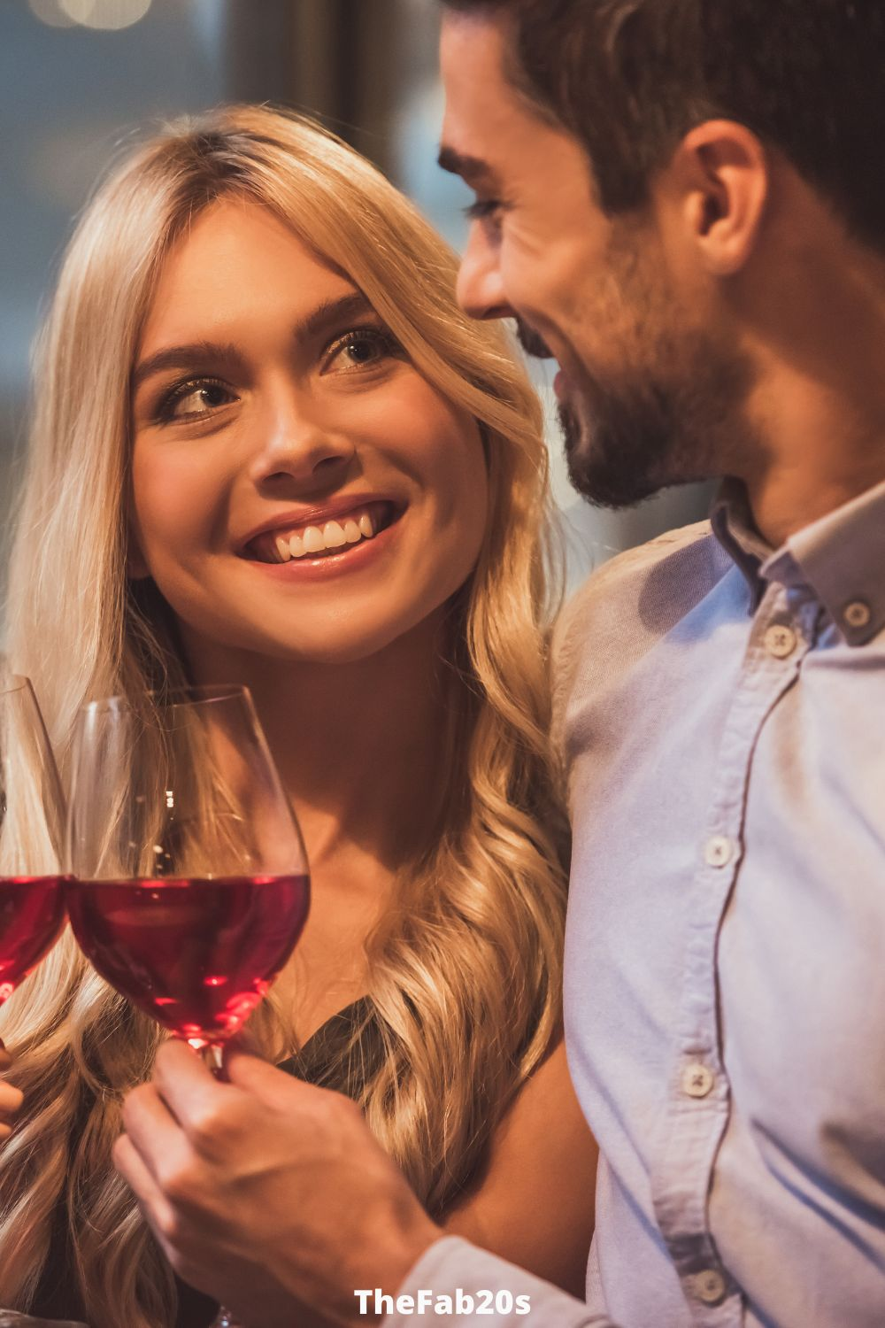 Couple smiling at each other, drinking wine - Featured in: Signs An Older Man Is Falling In Love With You