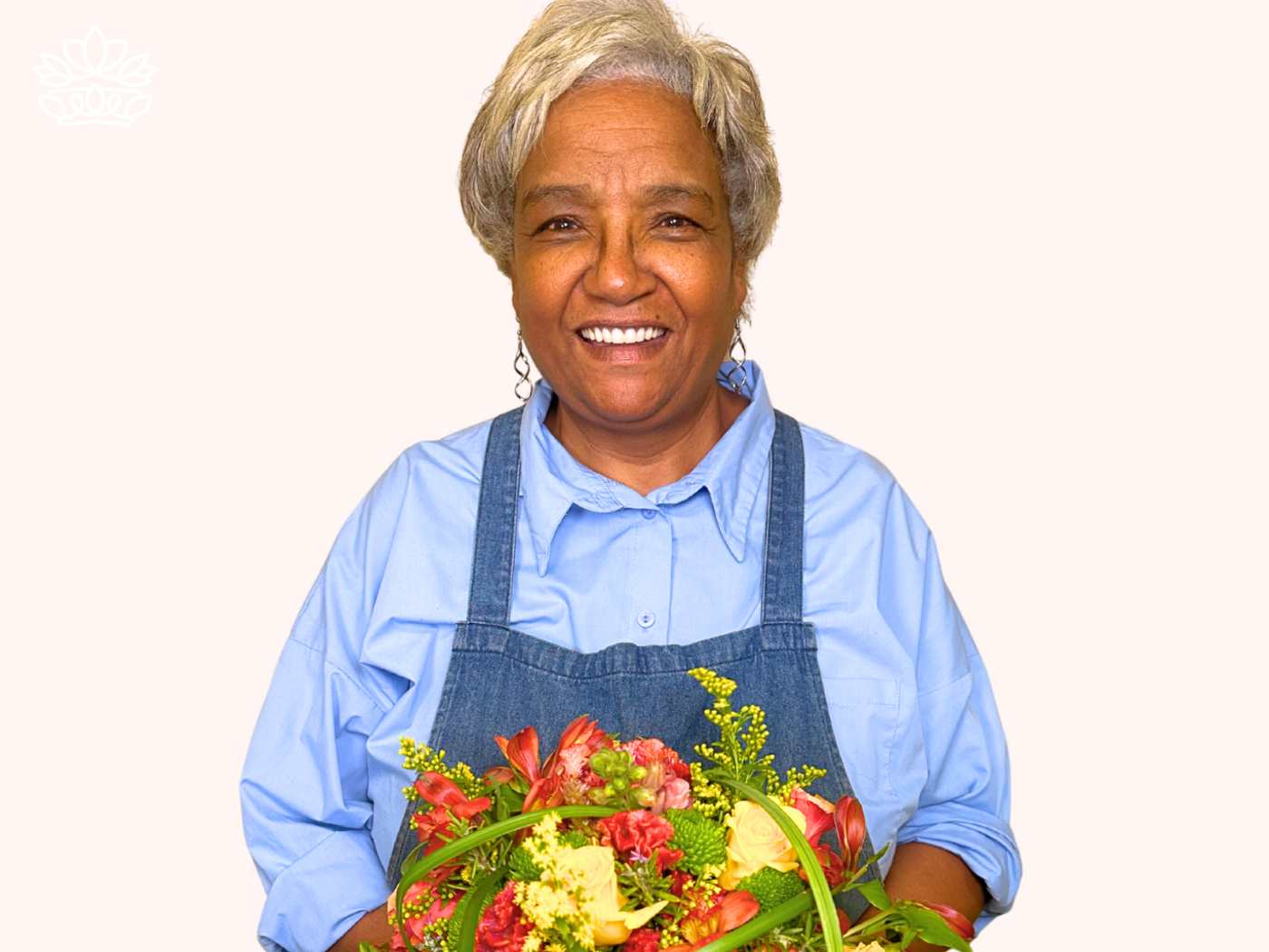 Cheerful senior florist displaying a colorful bouquet from the Florist Choice Bouquets Collection, with a guaranteed service of smiles and quality. Ideal for online orders where beautiful happenings are delivered. Fabulous Flowers and Gifts.