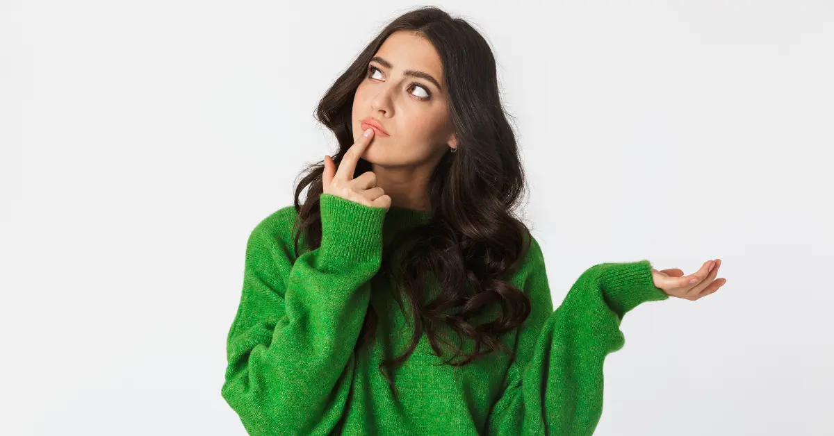 A woman thinking deeply about forming a multi-member LLC OnlyFans setup.