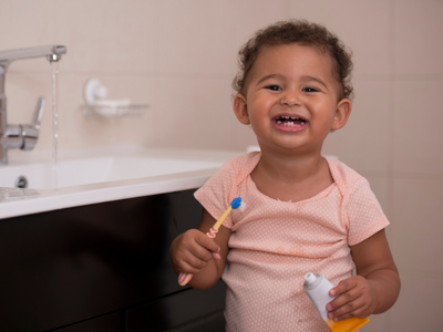 Little toddler brushing their teeth