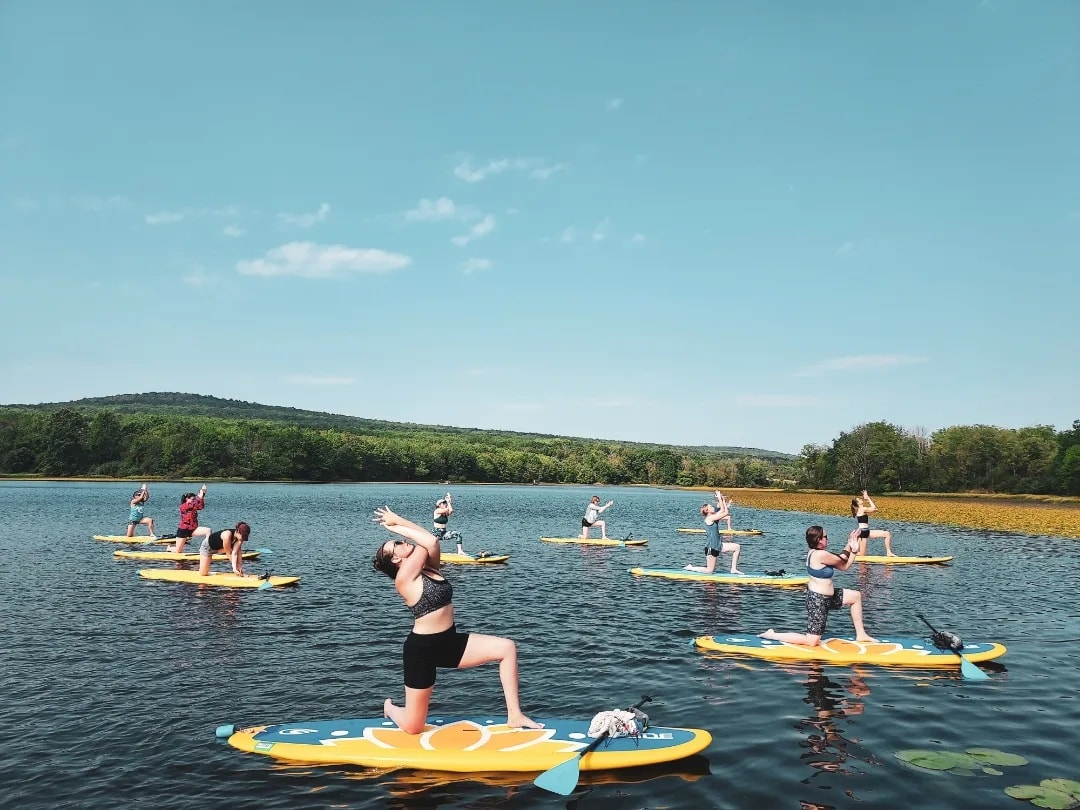 sup paddles and a sleeping bag for SUP yoga on stand up paddle board