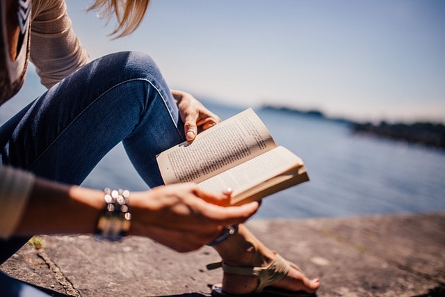 A woman reading on the beach.