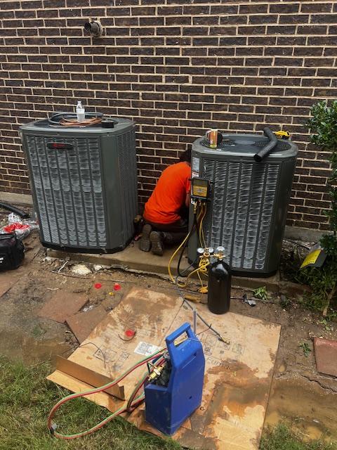 The image depicts a Trane HVAC installation in DFW Texas, showcasing a team of HVAC technicians working on both the indoor and outdoor units of a new air conditioning system. The scene highlights the importance of energy efficiency and proper installation for optimal cooling and heating performance.