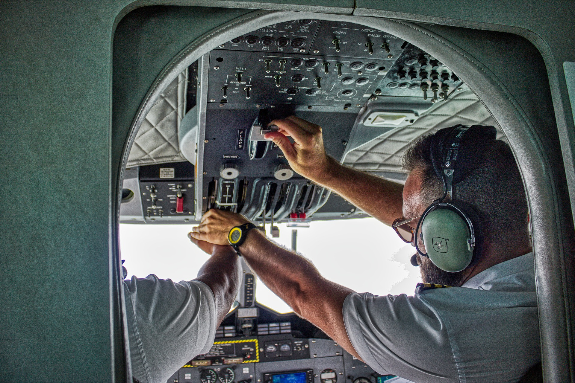 A pilot student being taught by the instructor how to use aircraft controls
