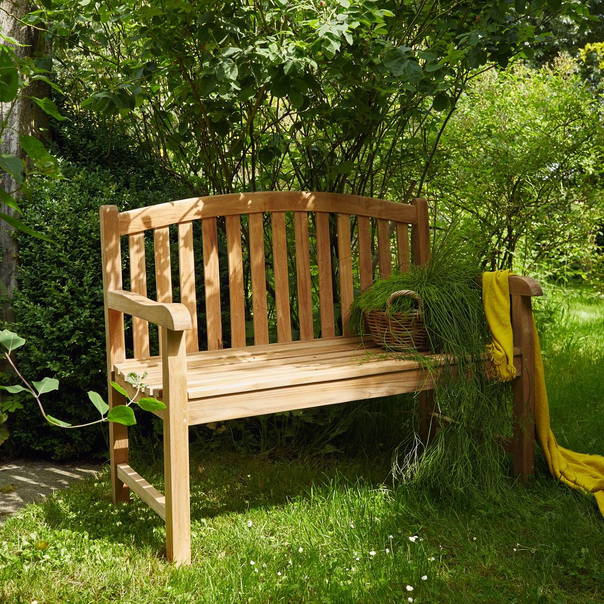 Banc de jardin en teck massif Wilsa Garden installé sur une terrasse extérieure avec dossier et assise en bois naturel résistants aux intempéries