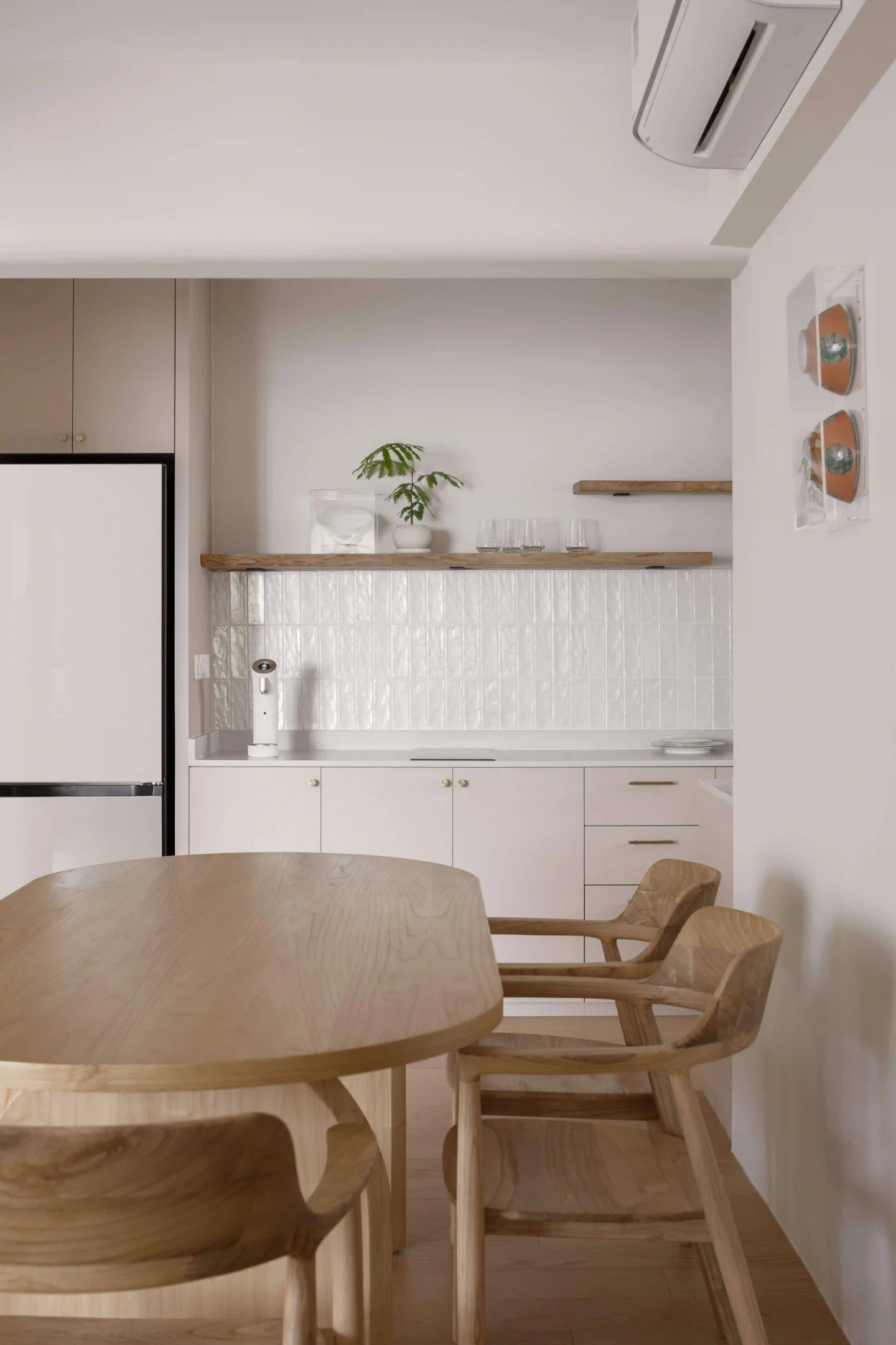 Light-timber kitchen with textured tile backsplash and quartz top in HDB unit