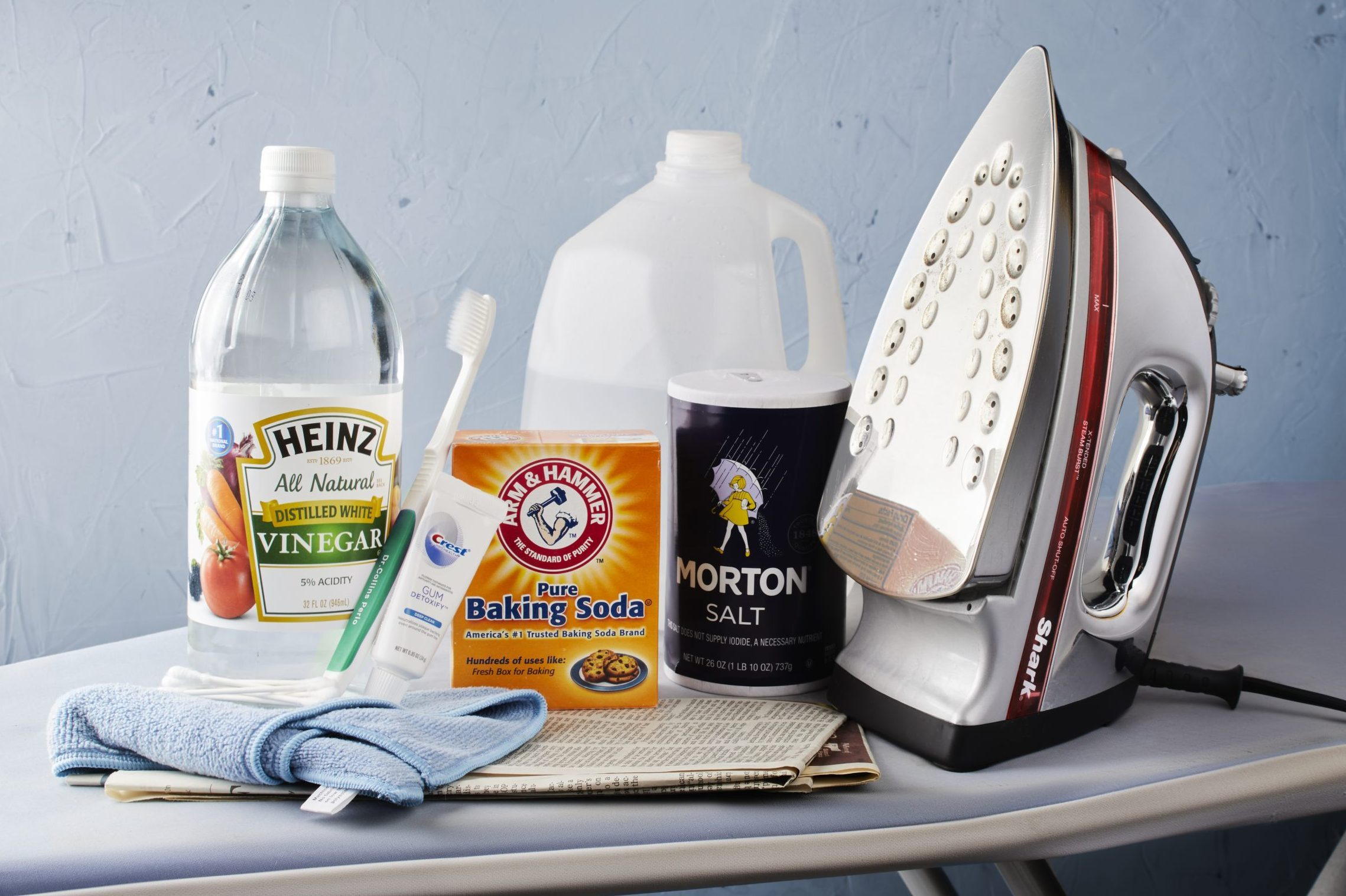 Use distilled water and distilled white vinegar to clean an iron