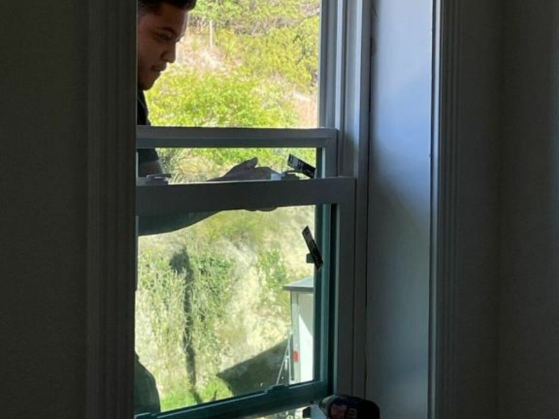 An image showing professional window installation by Spartan Roofing & Siding in San Antonio.