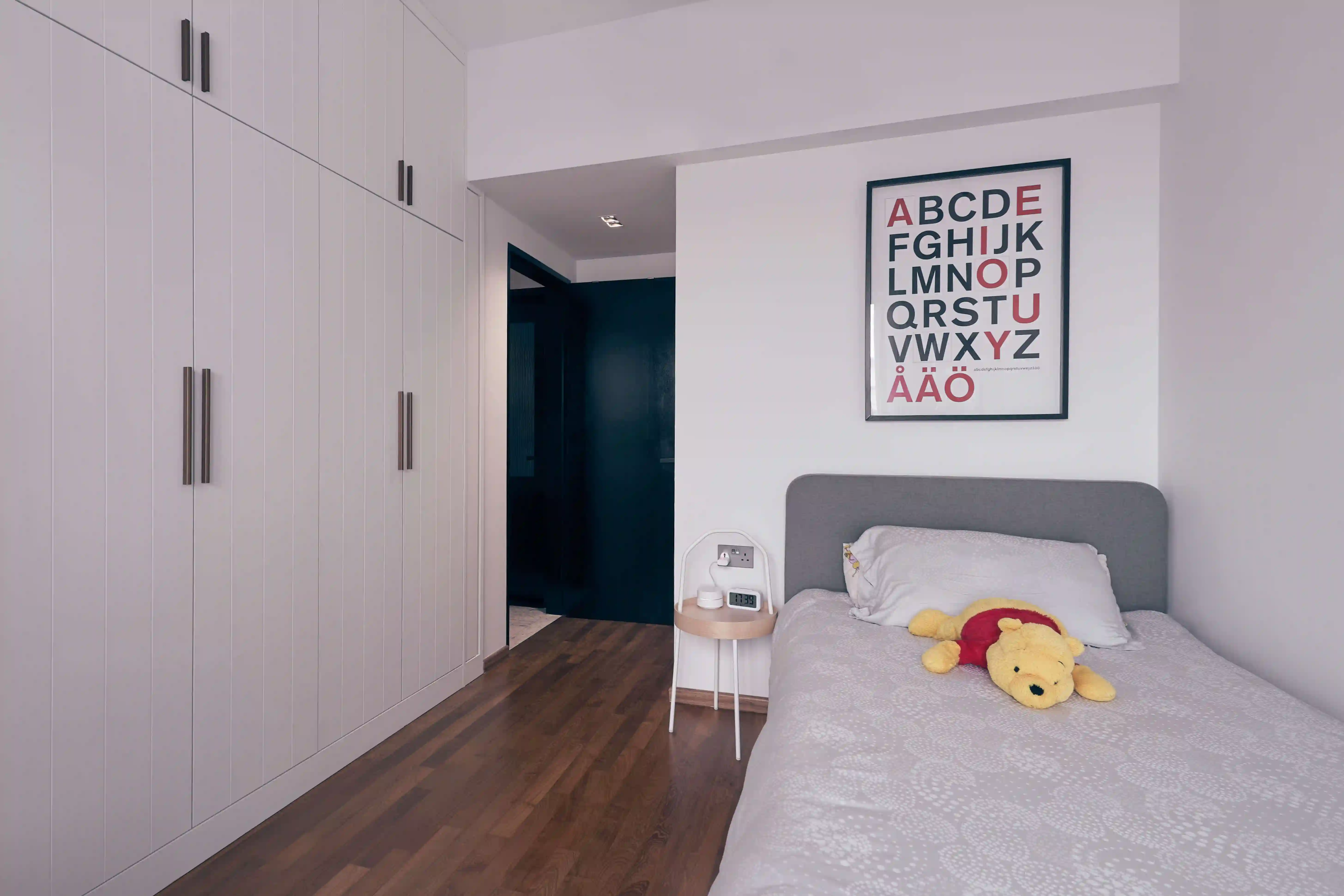 Full-height wardrobe and slim single bed maximise walkway – clever bed ideas for small rooms.
