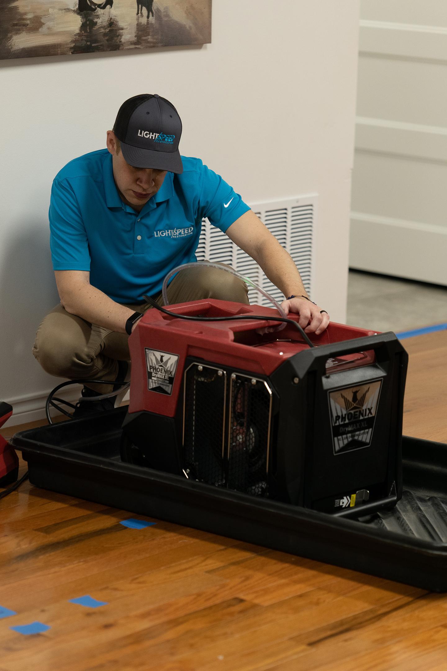 The image shows water restoration equipment, including industrial-grade dehumidifiers and drying equipment, actively drying the flooring and walls of an Austin home affected by water damage. This setup is part of the water damage restoration process, aimed at preventing mold growth and restoring the affected areas to their pre-loss condition.