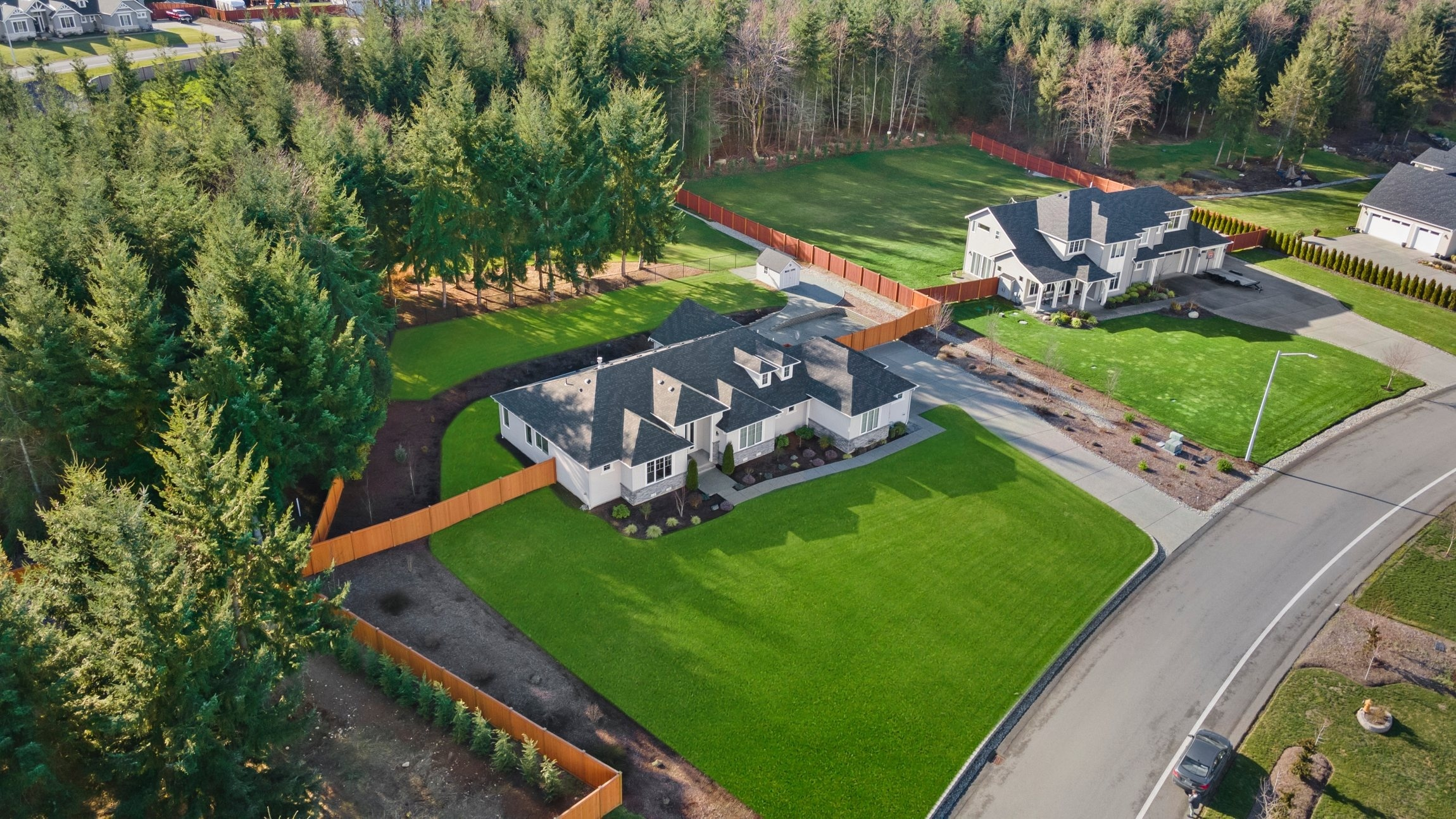 aerial view two homes with lush green yard