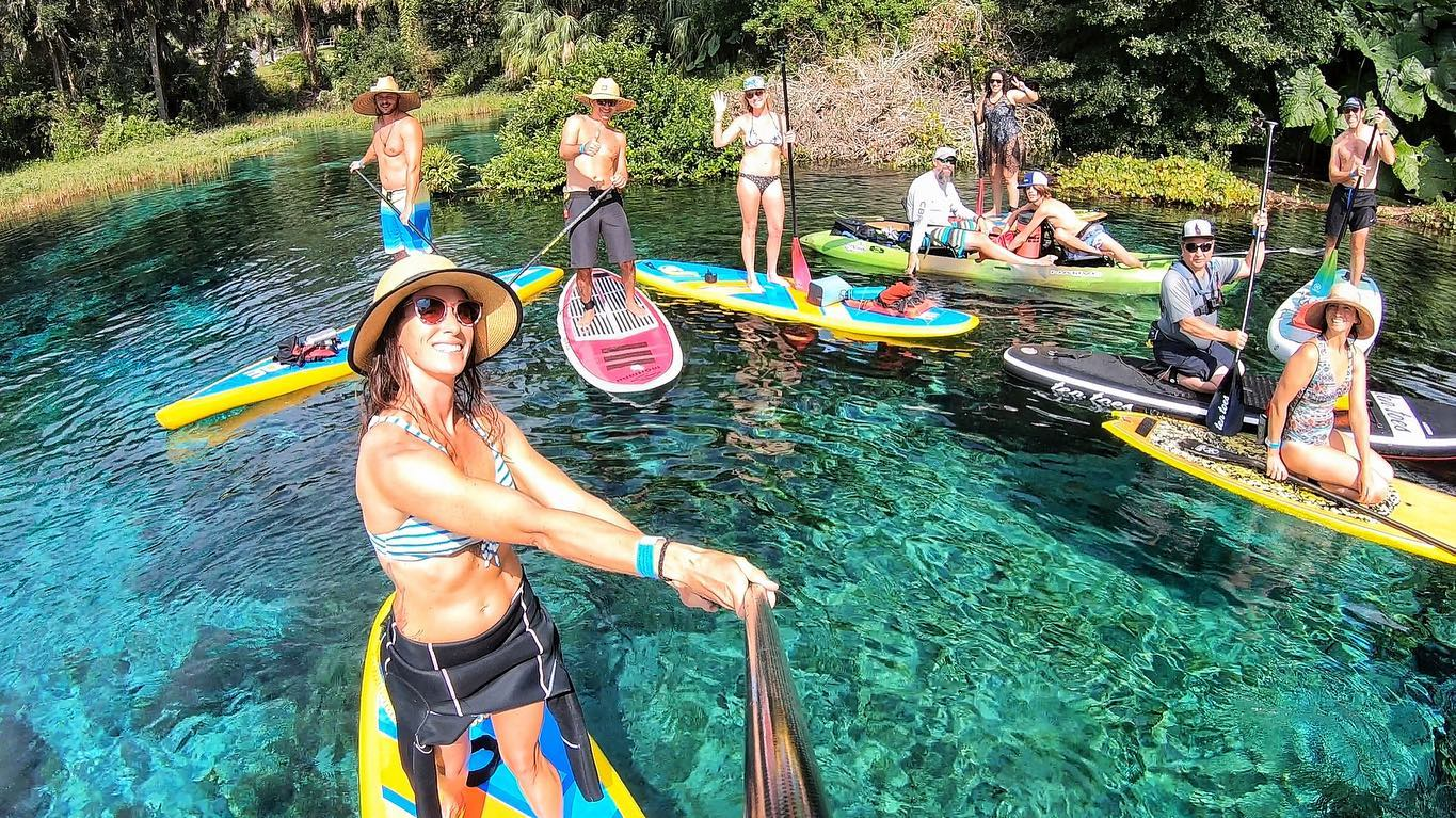 group on stand up paddle boards