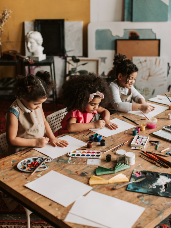 children having fun learning about art history and painting in a room next to the park