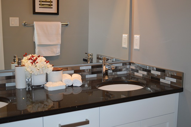 double sinks vanity with bathroom essentials - fresh flowers, cotton balls, perfume bottles