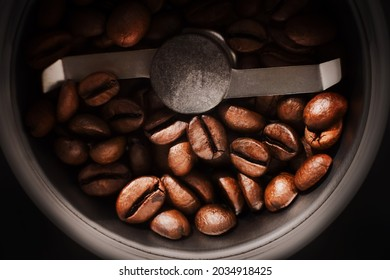 A top down view of a blade coffee grinder in action