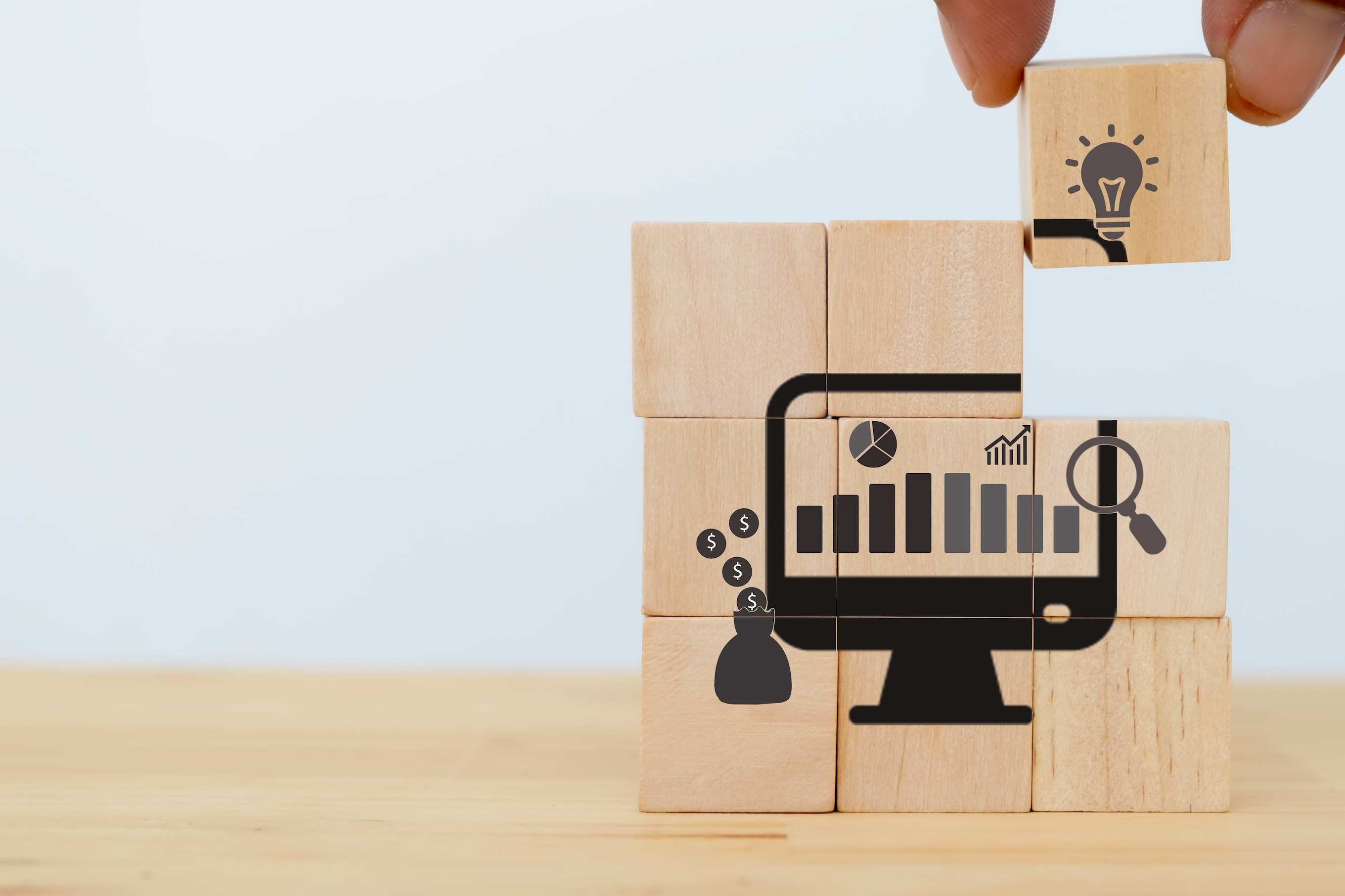 wooden blocks piece together a dark icon of a computer monitor and marketing graphics