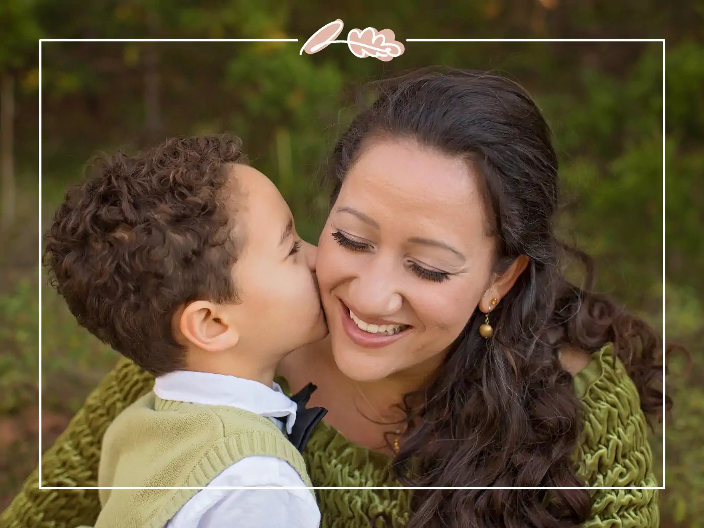 Young boy kissing his mother's cheek in the park, fabulous flowers and gifts