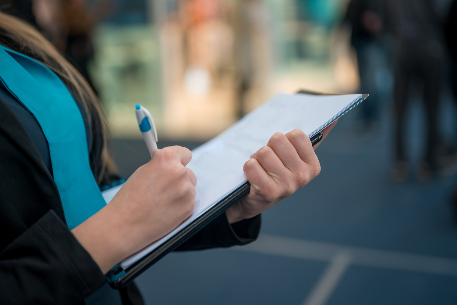 A woman holding a checklist on a clipboard.