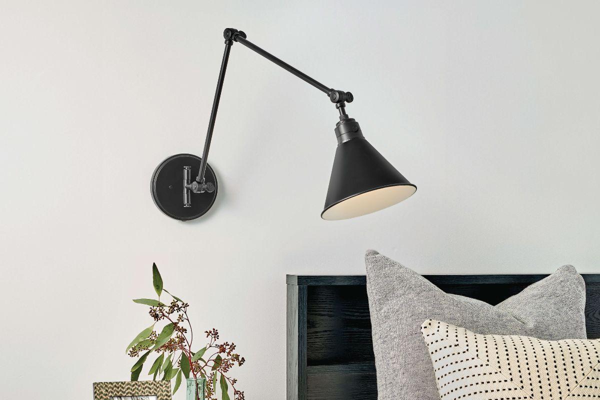 Swing arm wall light fixture ideas with adjustable black wall mounted light beside a bed in a modern bedroom