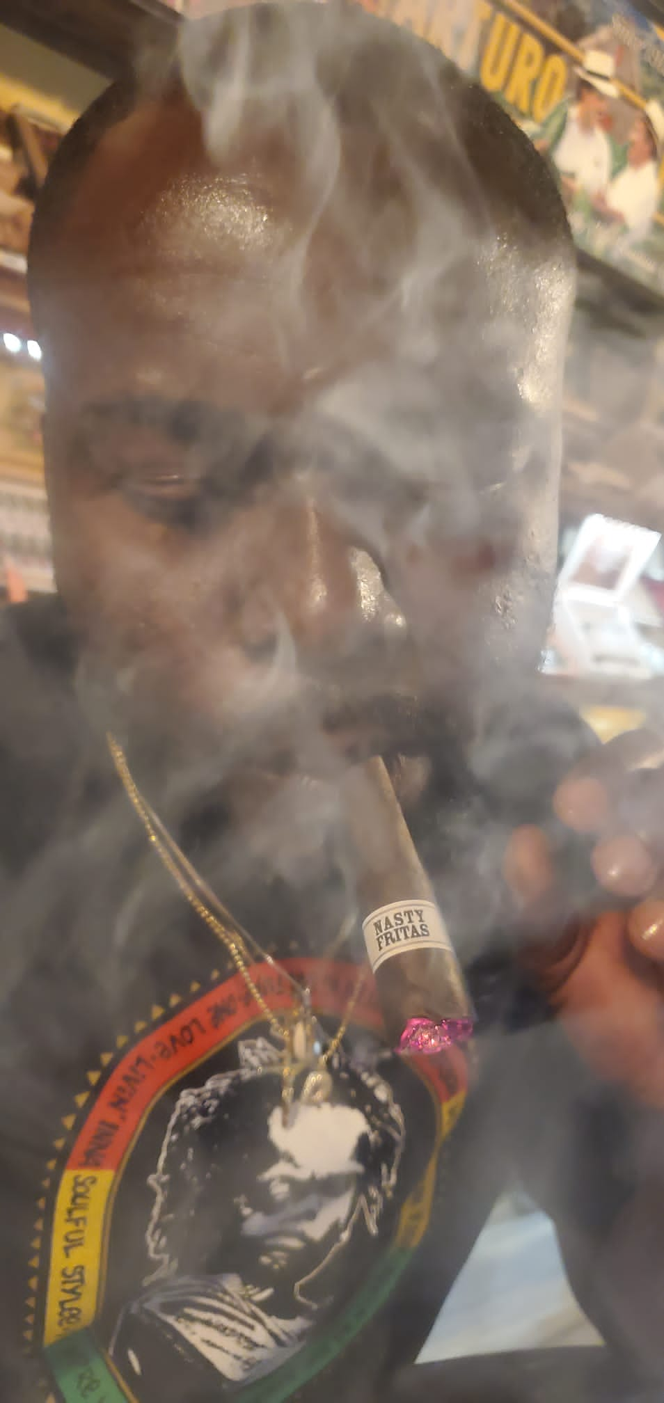 A man smoking a Liga Privada Nasty Fritas cigar