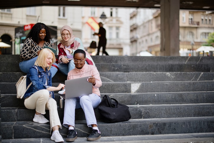 Group of college students sitting on the steps.