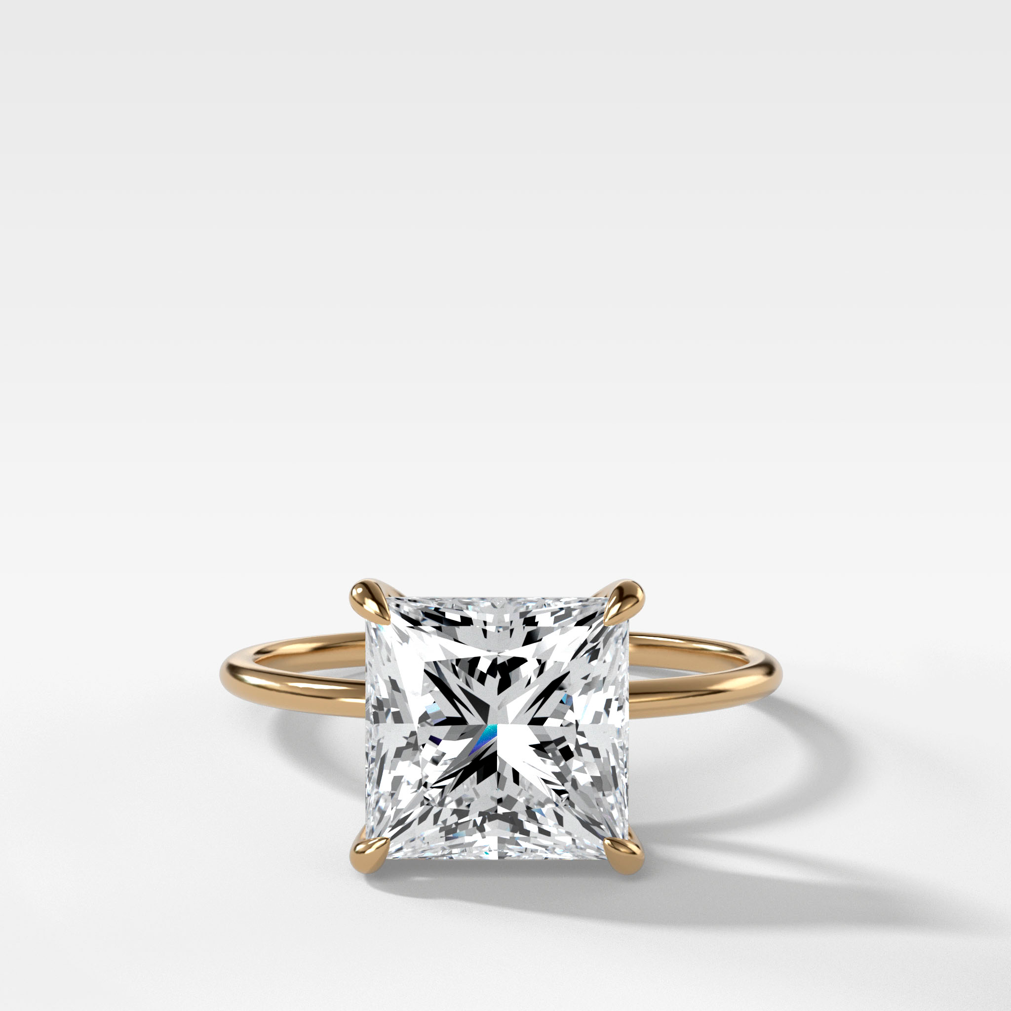 Thin Simple Solitaire with a Princess cut yellow gold