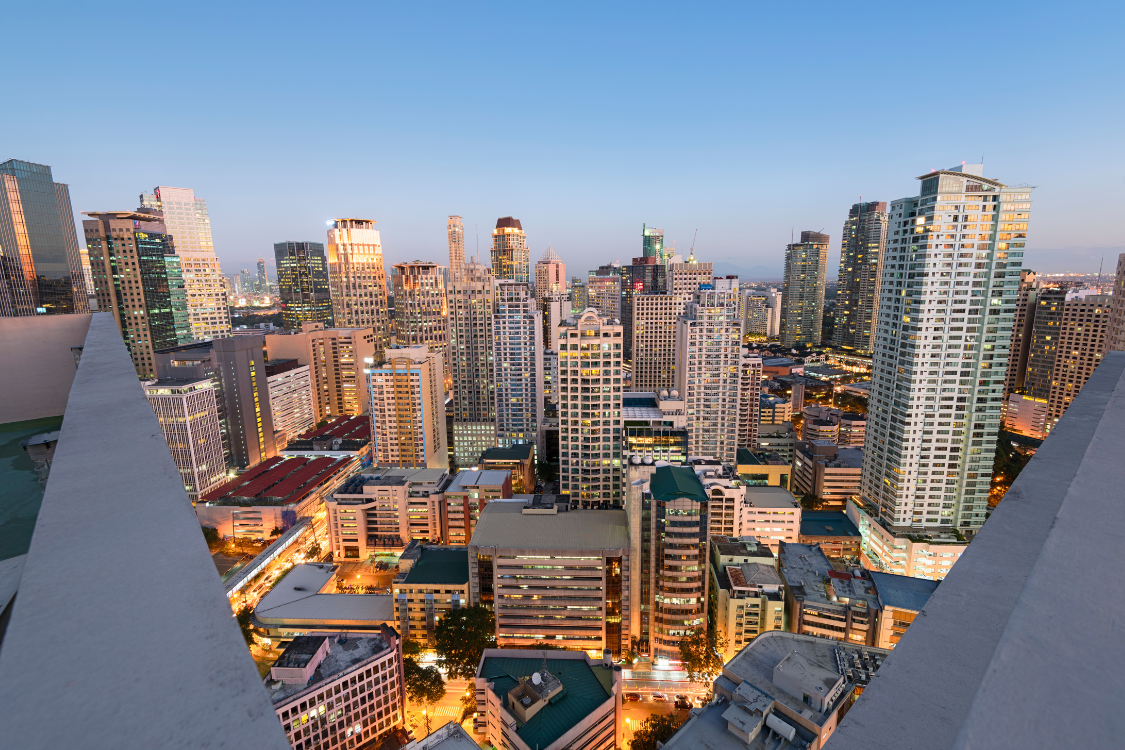 Aerial view of Metro Manila business district with high-rise buildings at sunset
