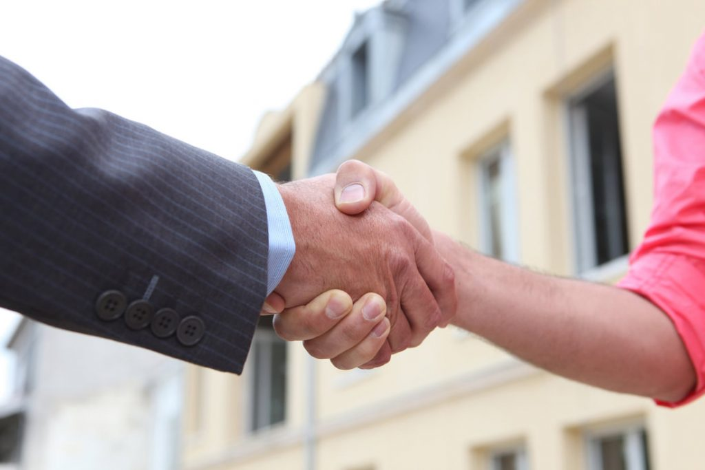 Handshake closing the deal of a cash house purchase