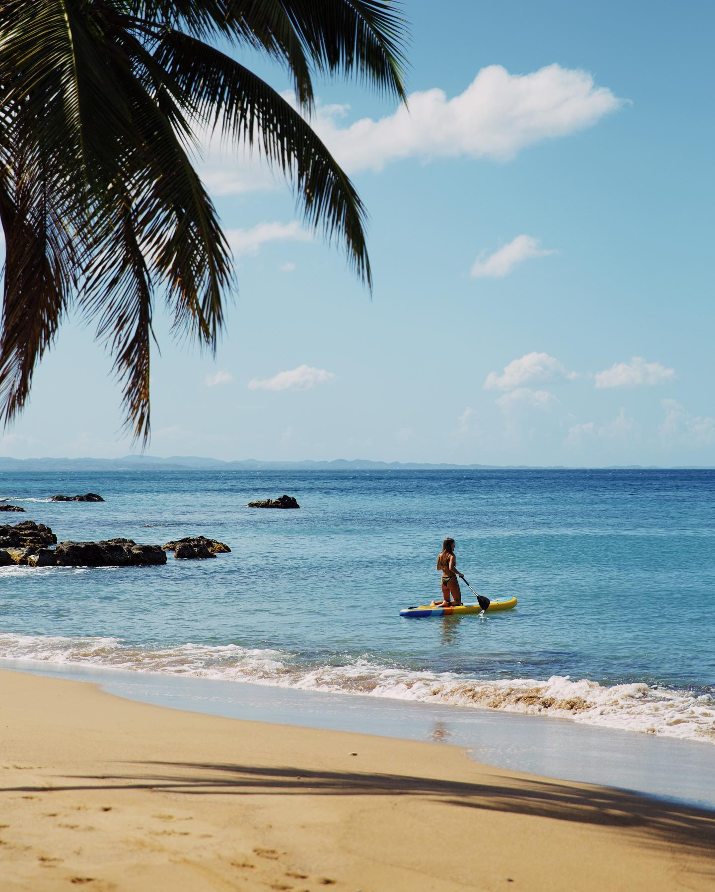 woman on an inflatable paddle board