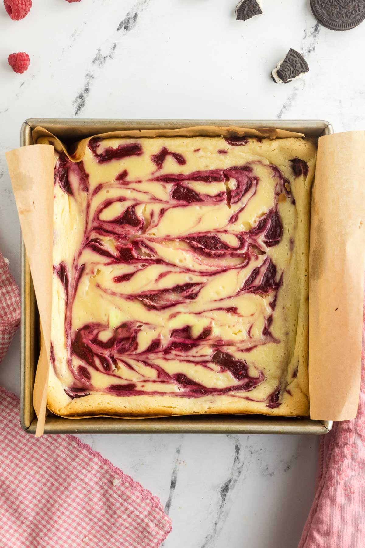 baked white chocolate raspberry cheesecake squares in pan