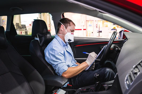 Person inspecting a car interior