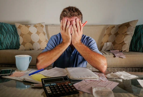 stressed man calculating tax