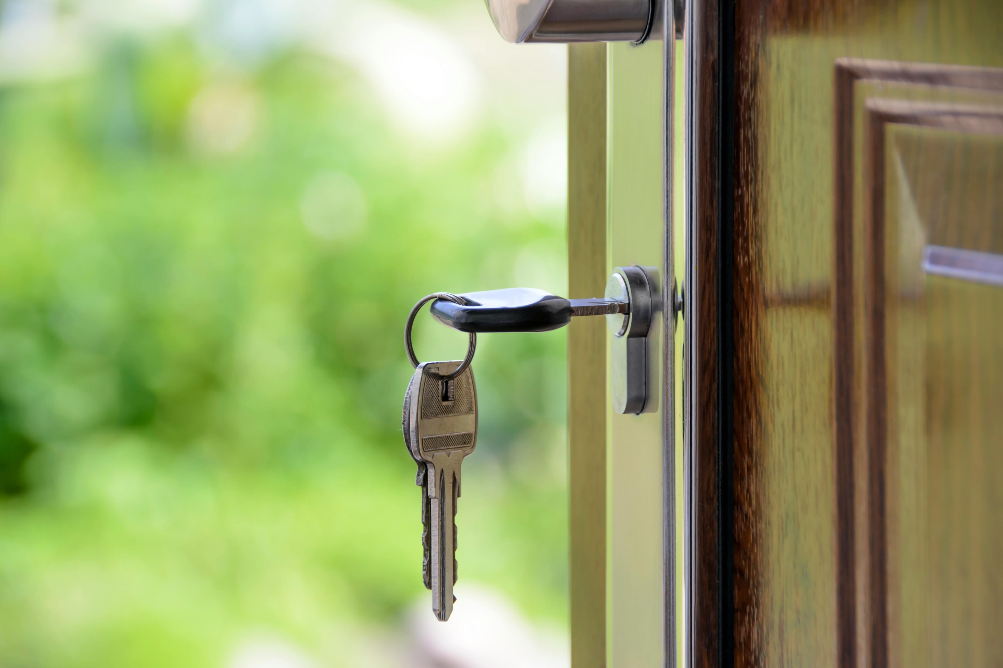 Key in door to house purchased by real estate investor.