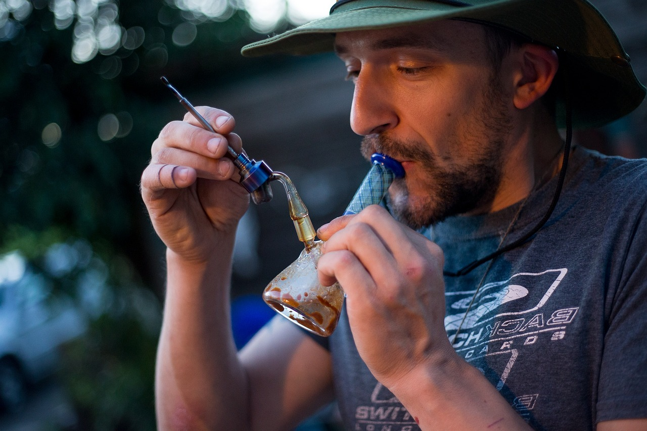 a man inhaling from a dirty dab rig