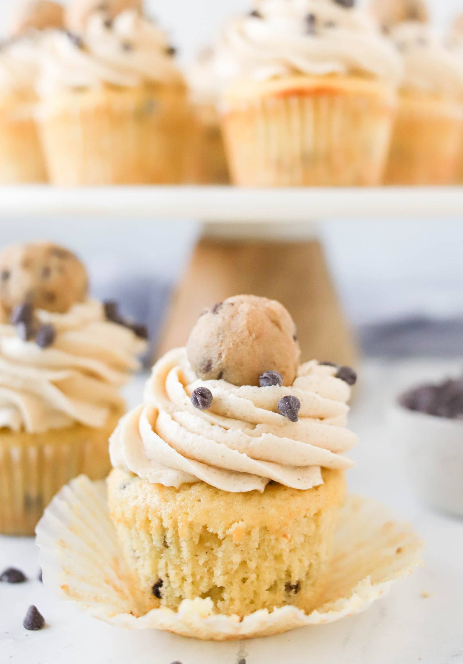 cookie dough cupcake with paper liner peeled away