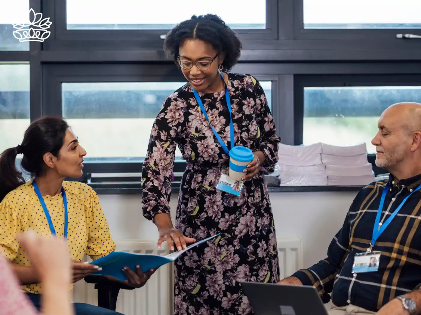 Engaged teacher discussing with colleagues in a workshop, highlighting the collaboration and professional development among educators, delivered with heart by Fabulous Flowers and Gifts.